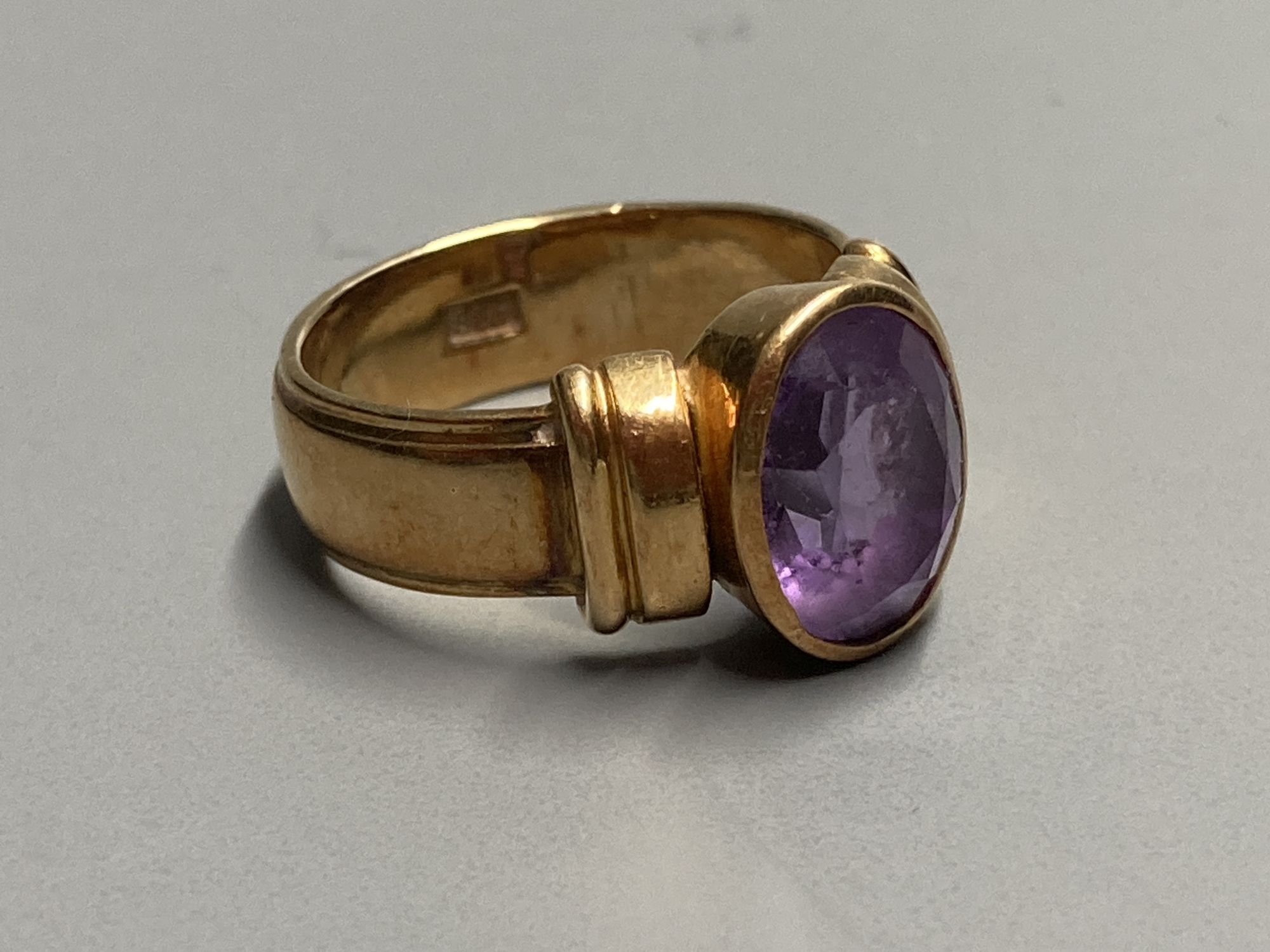 A 1950s? 585 yellow metal and amethyst set dress ring, size K, gross 7.3 grams.